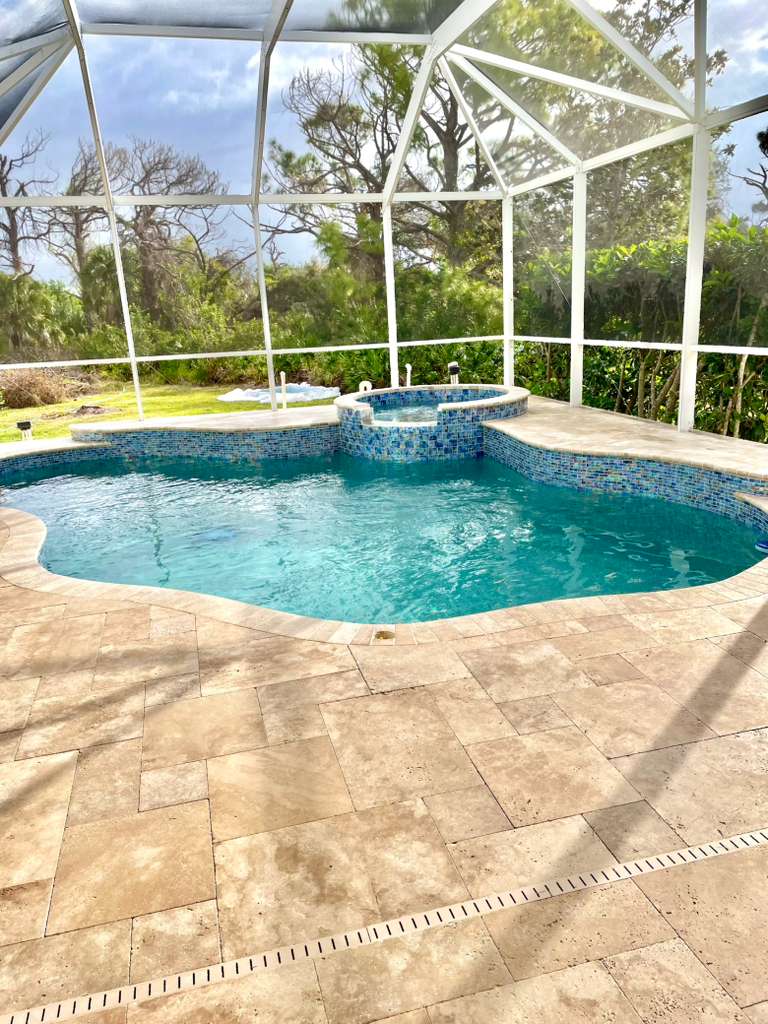After pool renovation - travertine deck and blue tile
