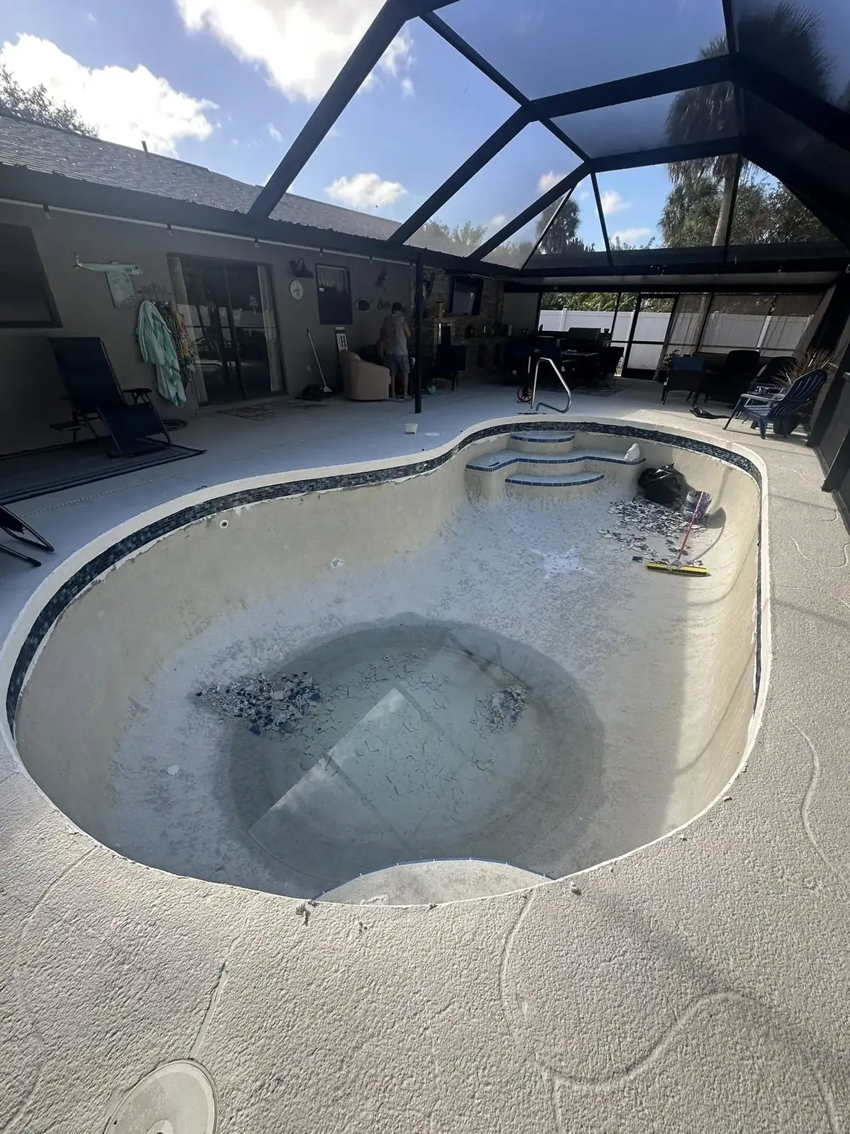 Before: drained pool with worn, rough shell