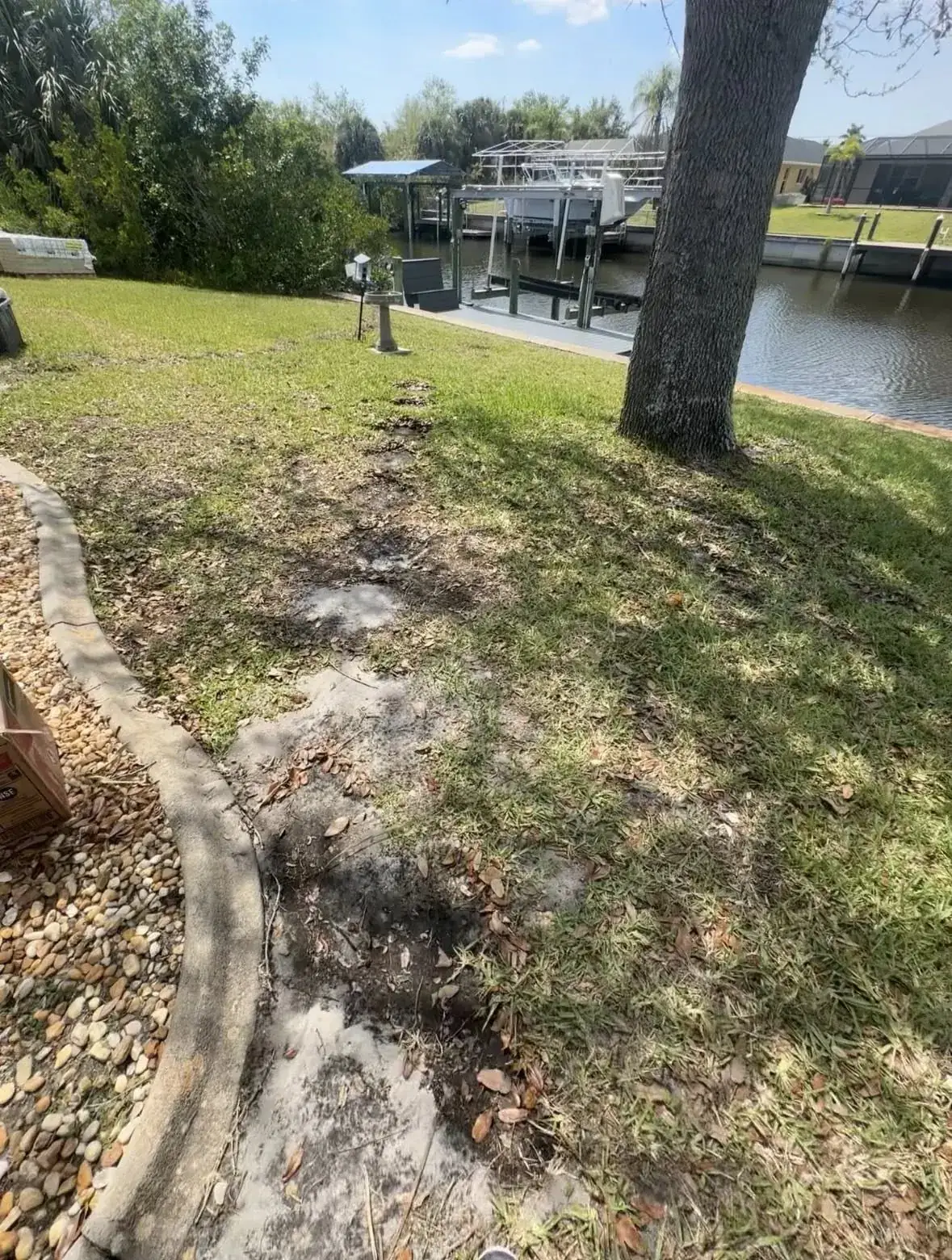 Before: grass and dirt path along waterfront yard